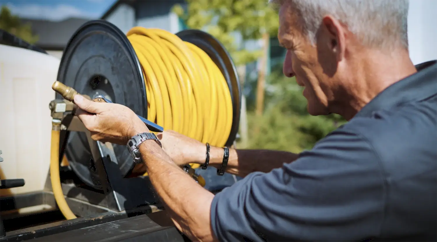 Technician preparing hose reel for pest control treatment